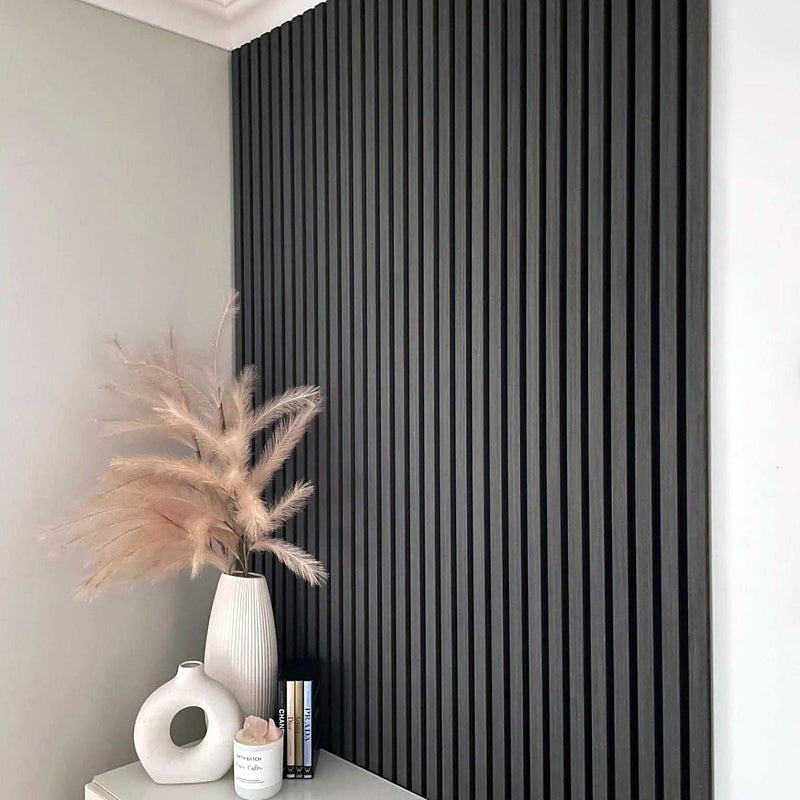 DecorMama Flexible Acoustic Slat Panel, black flexible acoustic slat panel on a living-room wall
